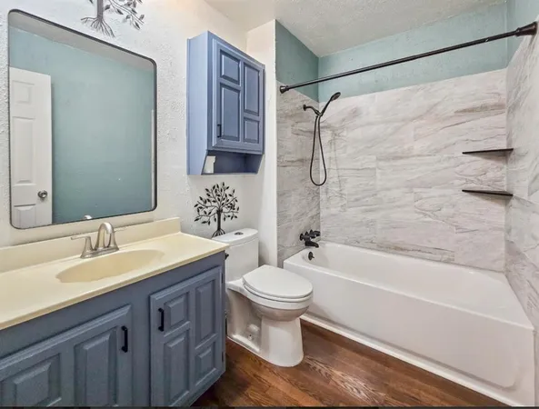 a bathroom with a sink toilet tub and shower
