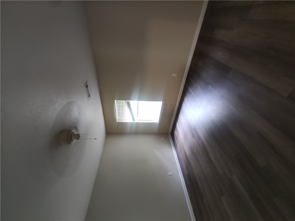 17 West Rainsong Street Farmington, AR 72730 - Photo 11 of 13 Spacious room featuring wood-finish flooring, a window with horizontal blinds, and a ceiling fan