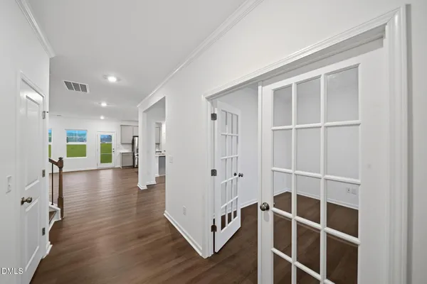 a view of a livingroom with wooden floor and windows