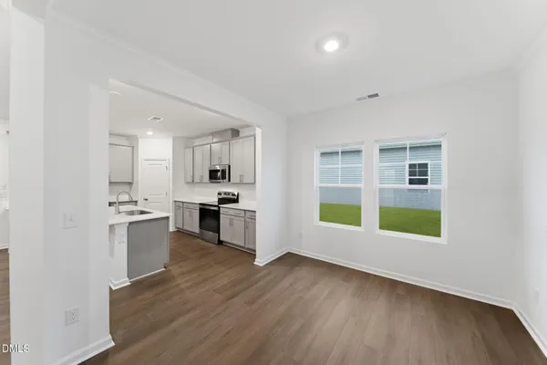 a large kitchen with a stove and a refrigerator