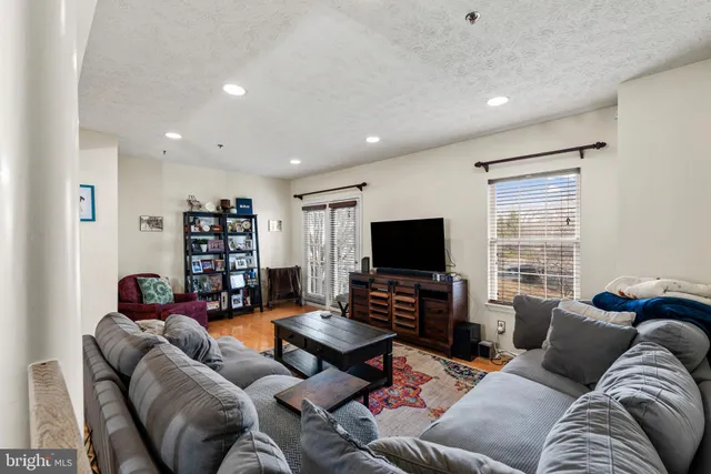 a living room with furniture and a book shelf