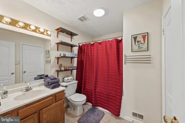 a spacious bedroom with a bed and large window