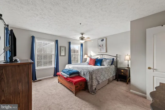 a bedroom with a bed and a television