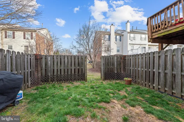 a view of wooden house with a small yard