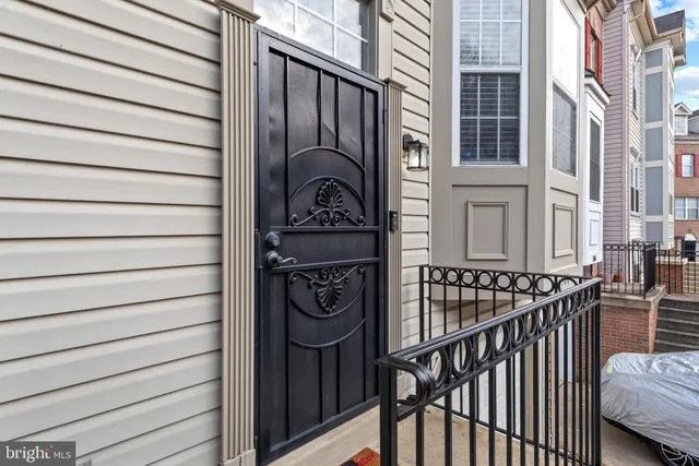 a view of a house with a door and wooden bench