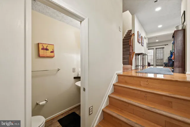a kitchen with a refrigerator a sink and cabinets
