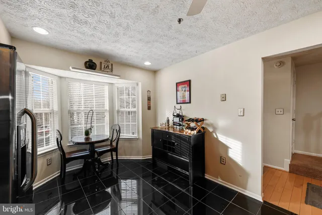 a kitchen with granite countertop a refrigerator stove top oven and sink