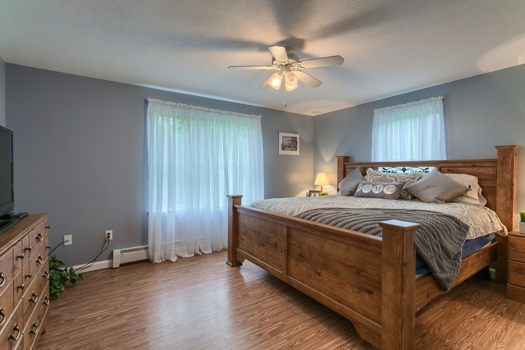 623 New Ipswich Road Ashby, MA 01431 - Photo 9 of 23 a bedroom with a bed and a chandelier