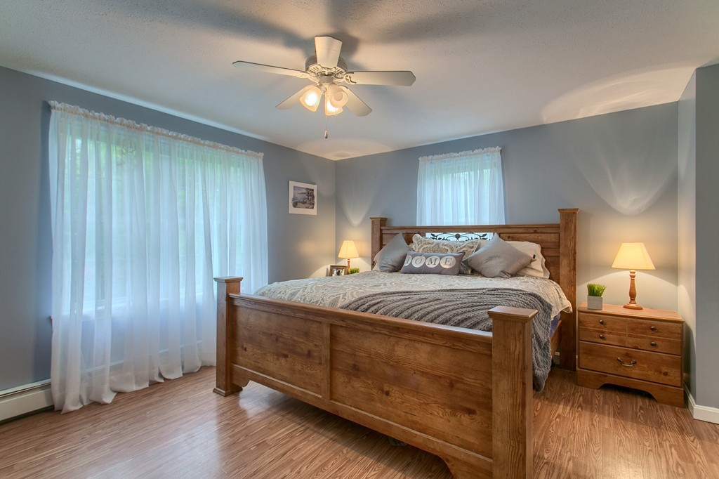 623 New Ipswich Road Ashby, MA 01431 - Photo 10 of 23 a bedroom with a bed and a chandelier