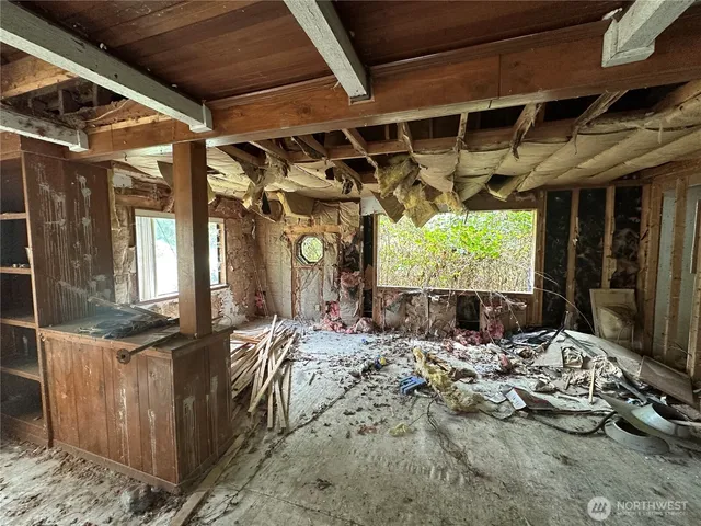 a view of a porch with furniture and a grill