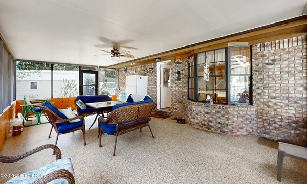 a living room with furniture and a floor to ceiling window