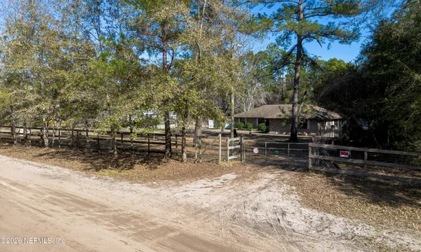 a view of house with yard and sitting area