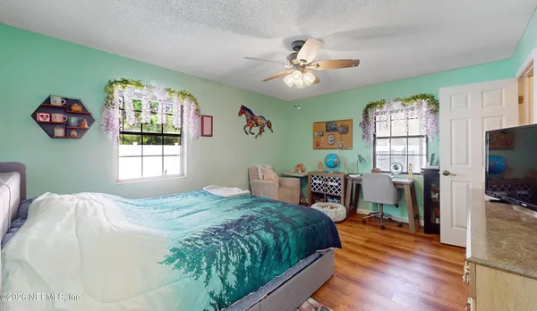 a bed room with a bed and a chandelier