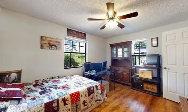 a view of a workspace with furniture and a flat screen tv