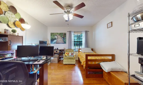 a bedroom with bed and a chandelier