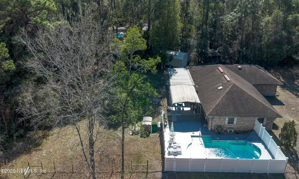 a backyard of a house with table and chairs