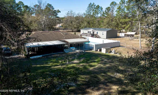 an aerial view of a house with a yard