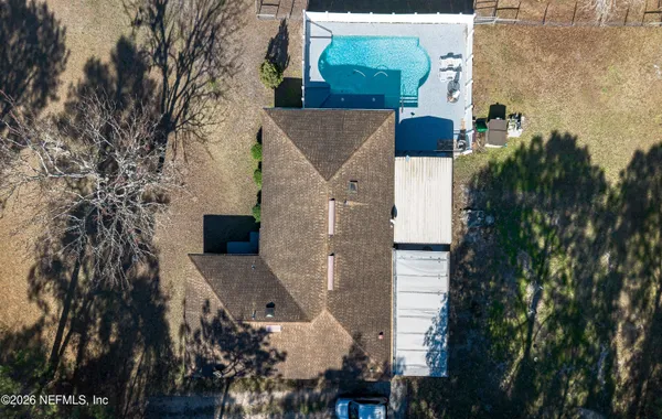 a view of backyard with green space and seating area
