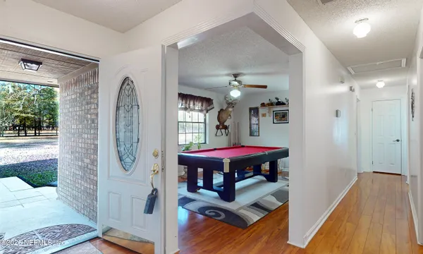 a view of a bedroom with furniture window and wooden floor