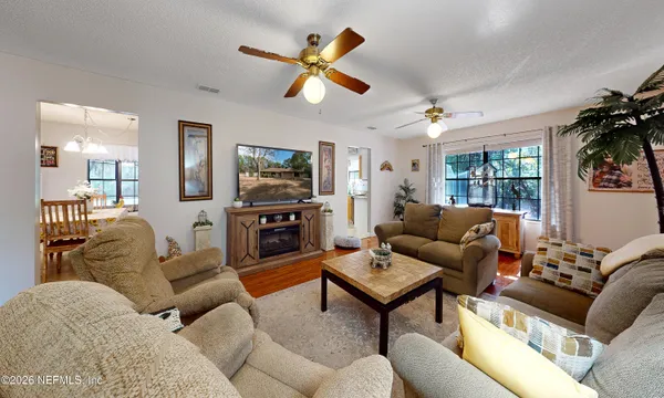 a living room with furniture ceiling fan and a rug