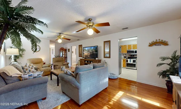 a living room with furniture and a potted plant