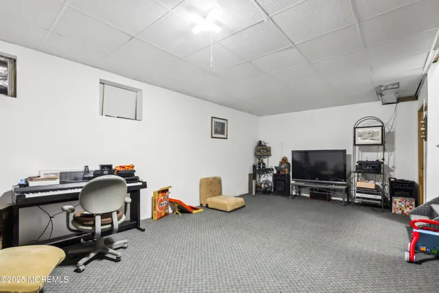 a view of a roof deck with table and chairs under an umbrella with wooden floor