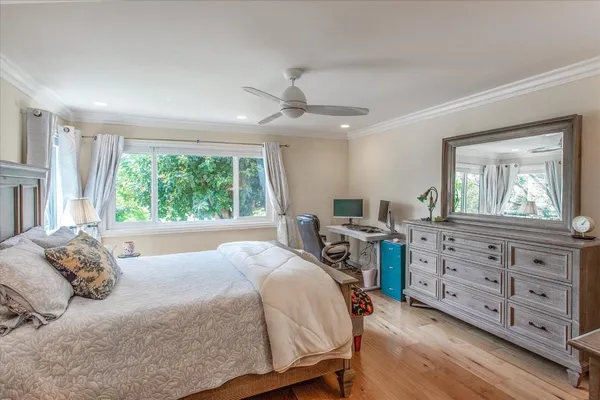 a bedroom with a large bed and a window
