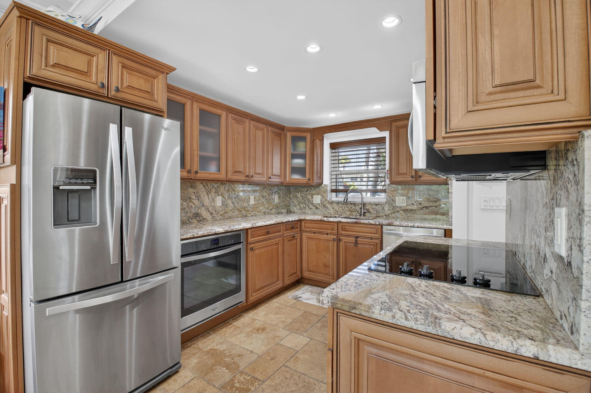 711 Northeast Harbour Terrace, Unit 3120 Boca Raton, FL 33431 - Photo 3 of 46 a kitchen with granite countertop stainless steel appliances and wooden cabinets