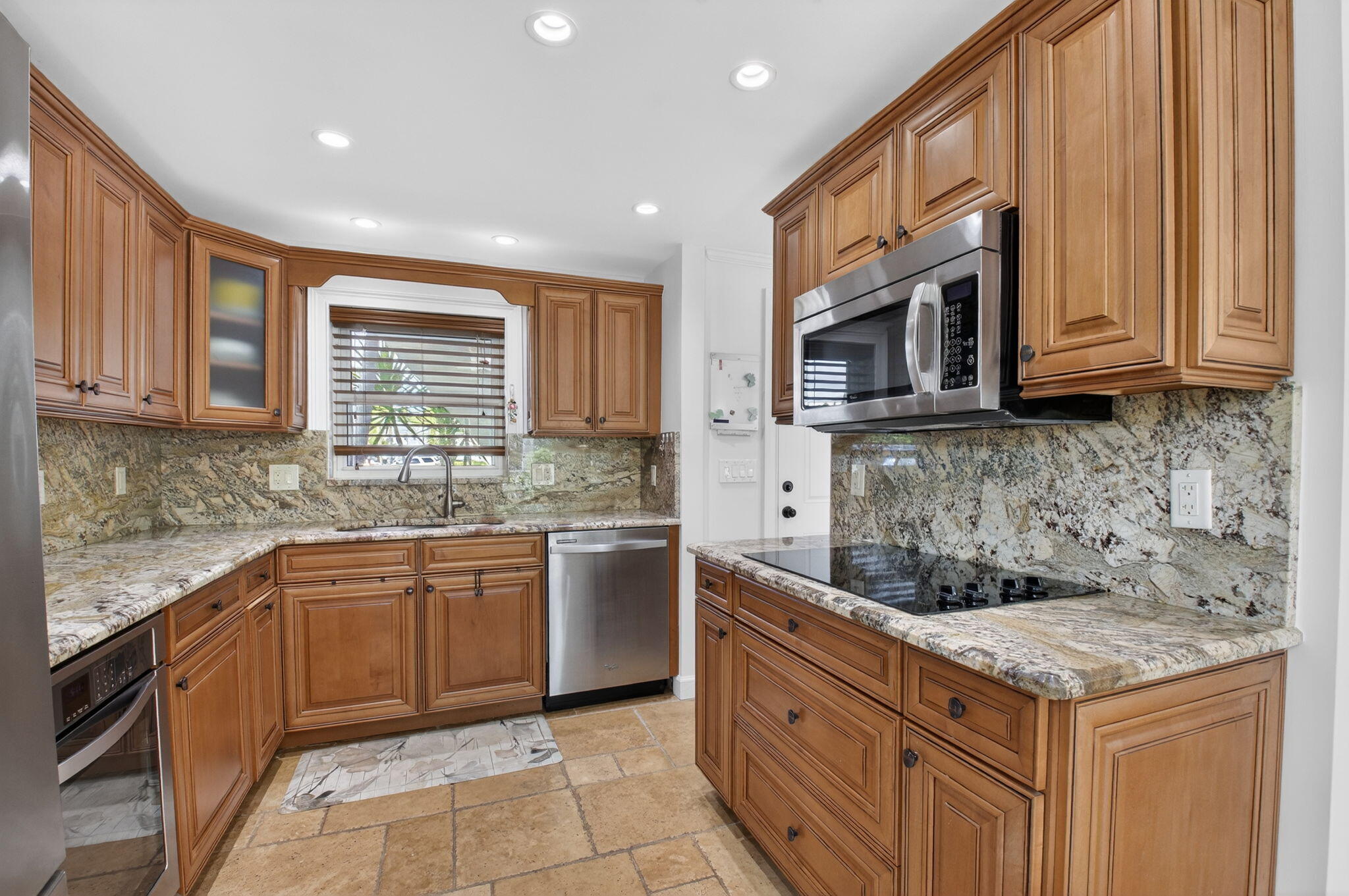 711 Northeast Harbour Terrace, Unit 3120 Boca Raton, FL 33431 - Photo 4 of 46 a kitchen with stainless steel appliances granite countertop a sink stove and cabinets