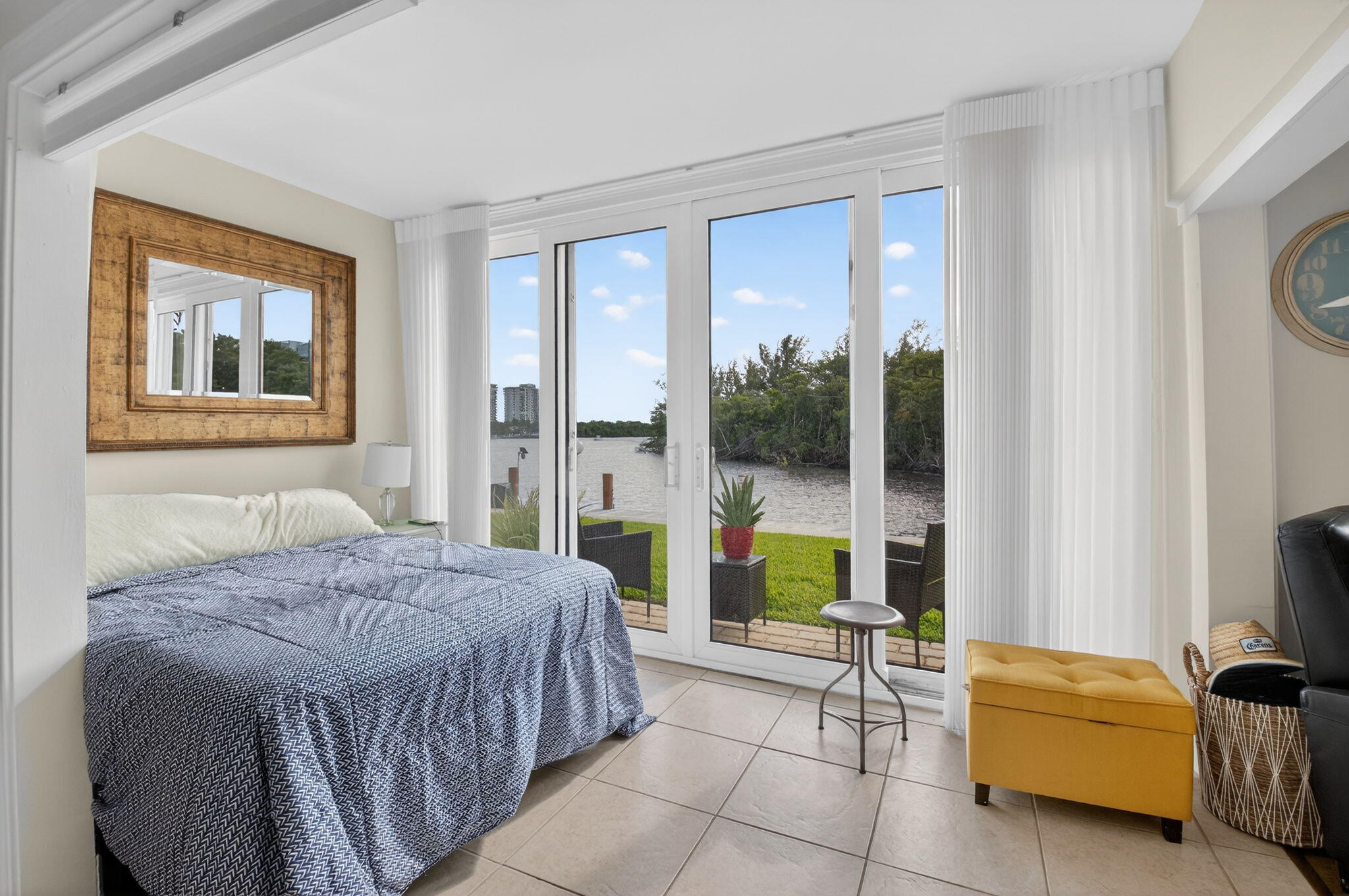 711 Northeast Harbour Terrace, Unit 3120 Boca Raton, FL 33431 - Photo 9 of 46 a bedroom with a bed and a couch next to a window