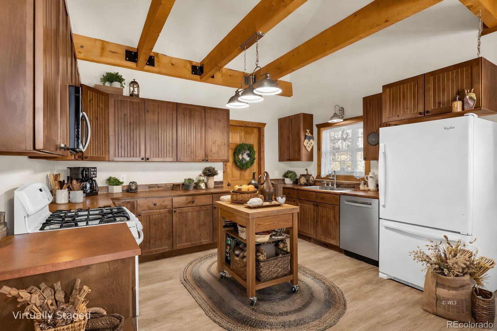 220 Rhonda Road Westcliffe, CO 81252 - Photo 11 of 35 a kitchen with a refrigerator and a stove