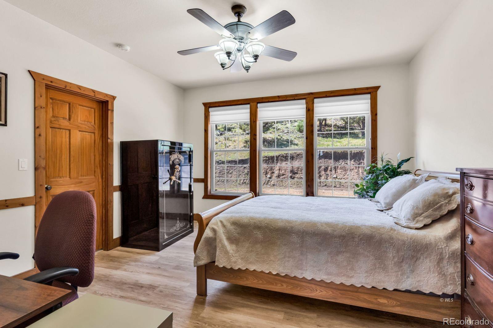 220 Rhonda Road Westcliffe, CO 81252 - Photo 12 of 35 a bedroom with a bed dresser and a window