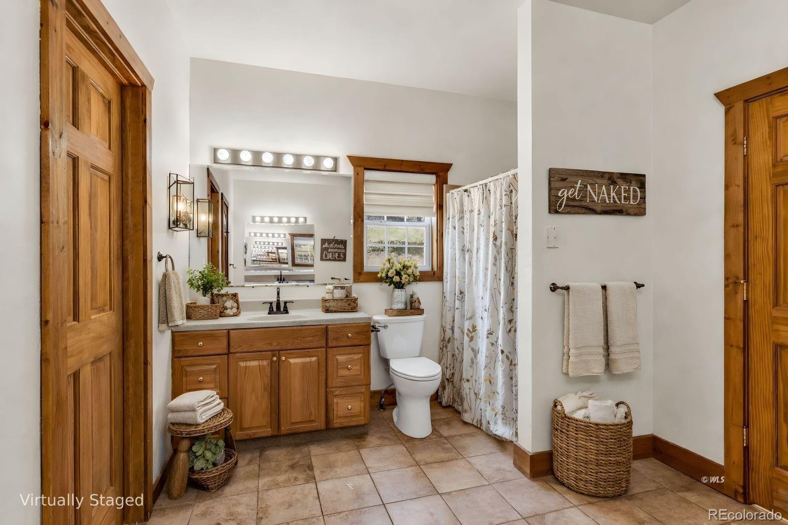 220 Rhonda Road Westcliffe, CO 81252 - Photo 14 of 35 a bathroom with a toilet a sink and a mirror