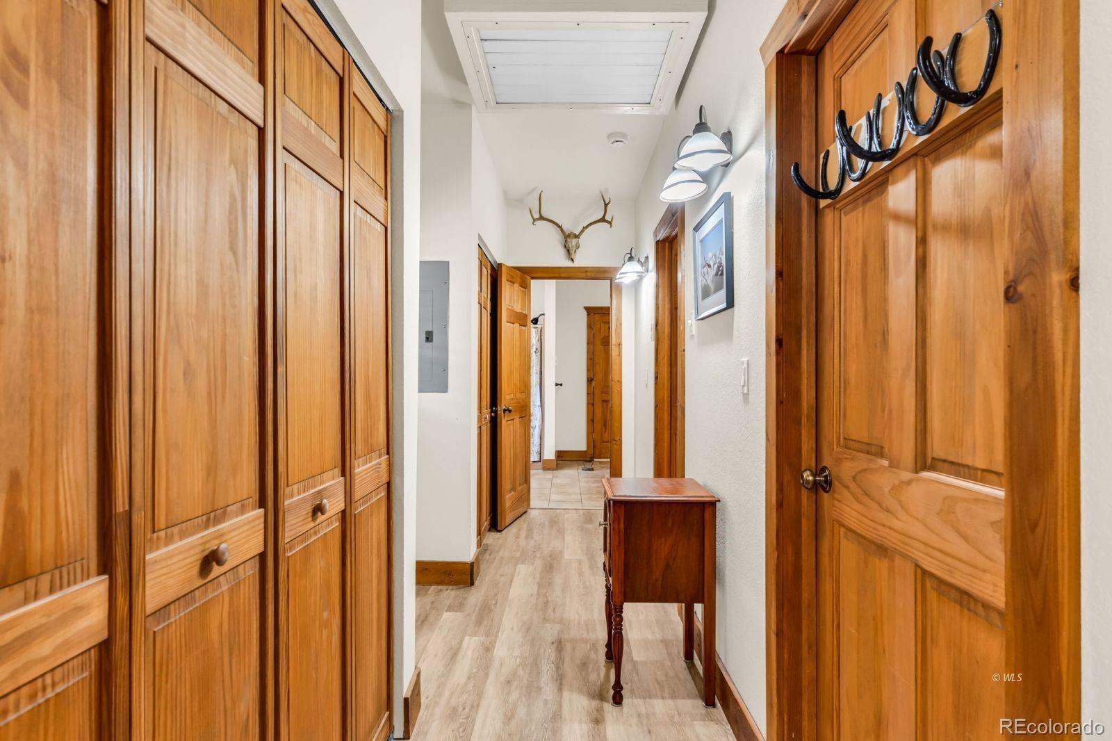 220 Rhonda Road Westcliffe, CO 81252 - Photo 17 of 35 a view of a hallway with wooden floor and stairs
