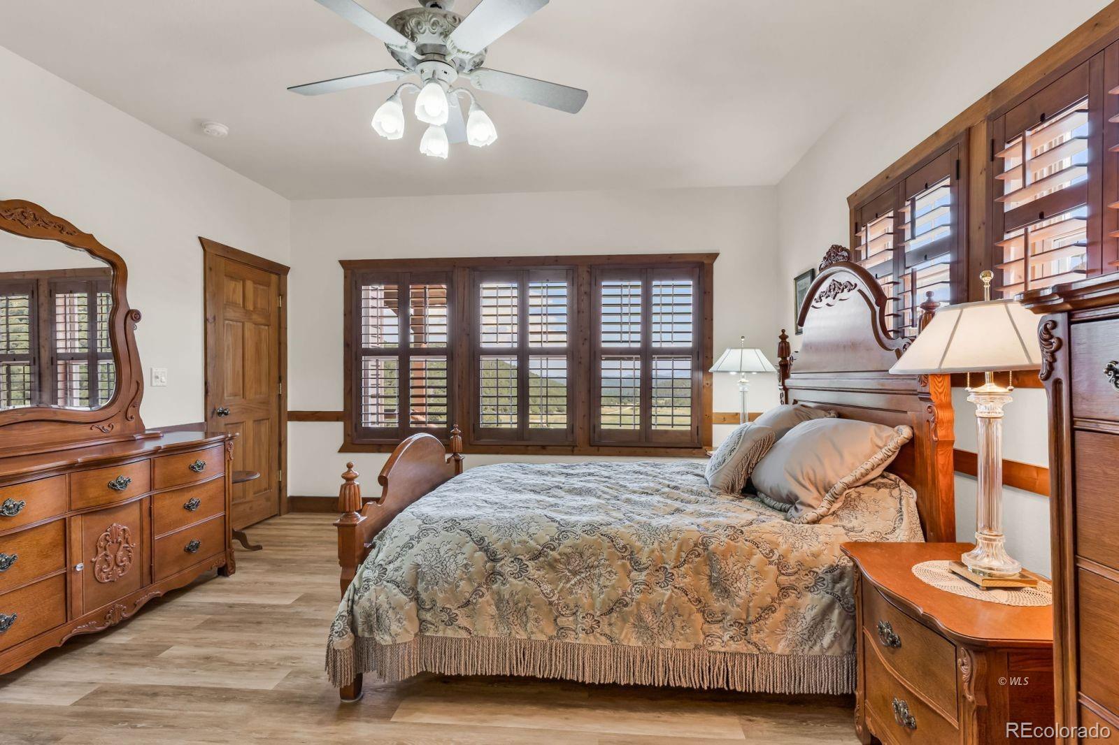 220 Rhonda Road Westcliffe, CO 81252 - Photo 22 of 35 a bedroom with a bed and wooden floor