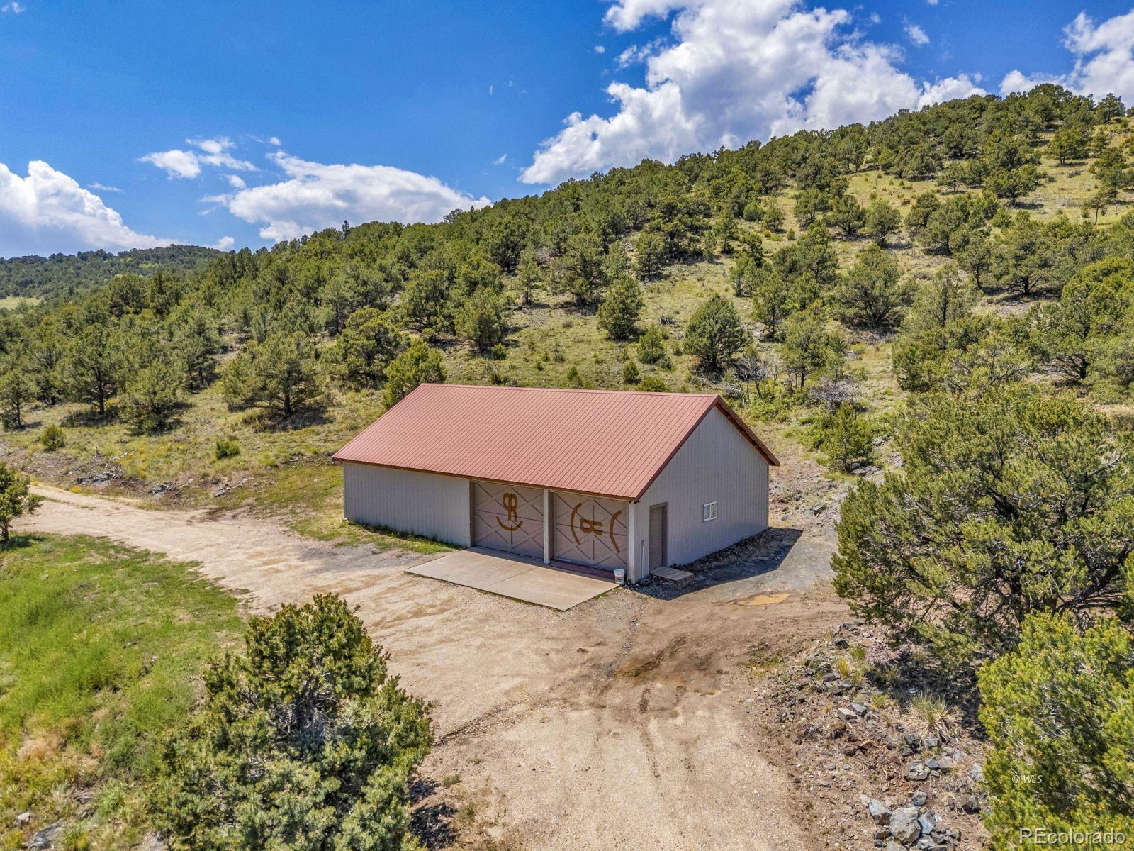 220 Rhonda Road Westcliffe, CO 81252 - Photo 32 of 35 a yellow and red house sitting in the middle of a yard