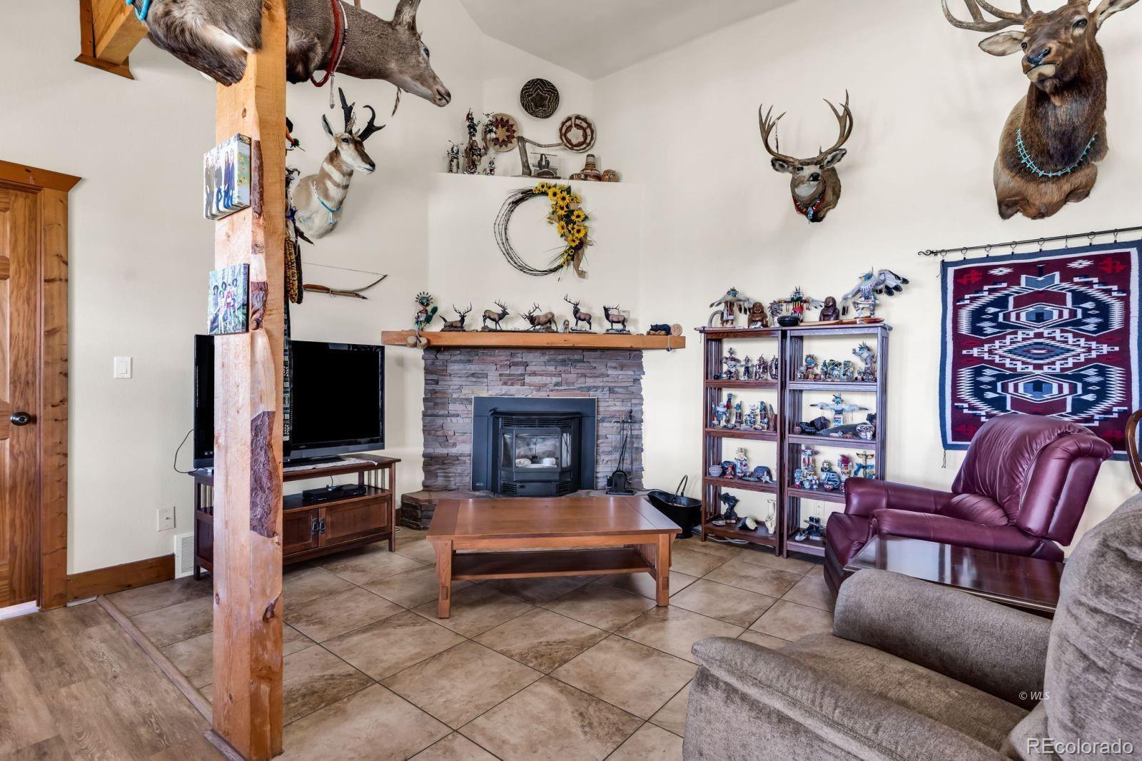 220 Rhonda Road Westcliffe, CO 81252 - Photo 5 of 35 a living room with furniture and a fireplace