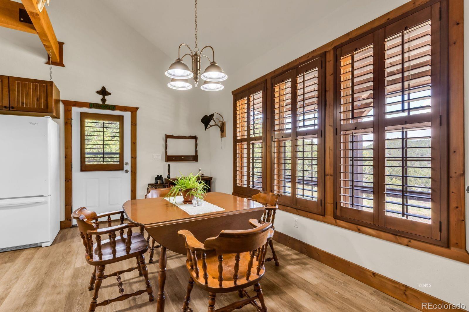 220 Rhonda Road Westcliffe, CO 81252 - Photo 7 of 35 a view of a dining room with furniture window and wooden floor