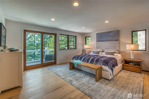 a spacious bedroom with a large bed and a large window
