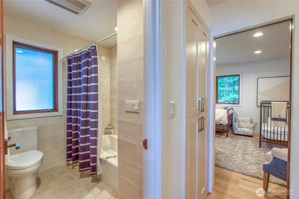 a bathroom with a toilet a sink and glass door