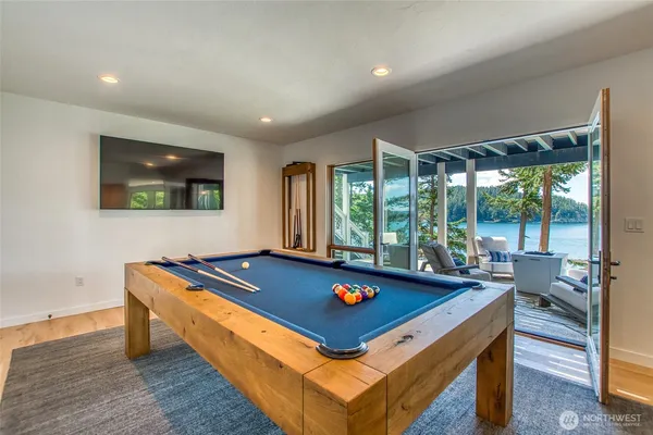 a room with pool table and windows