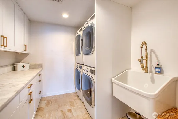 a bathroom with a sink a washer and dryer