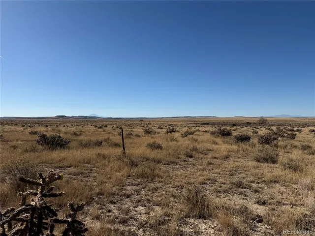 a view of a mountain range with trees in the background