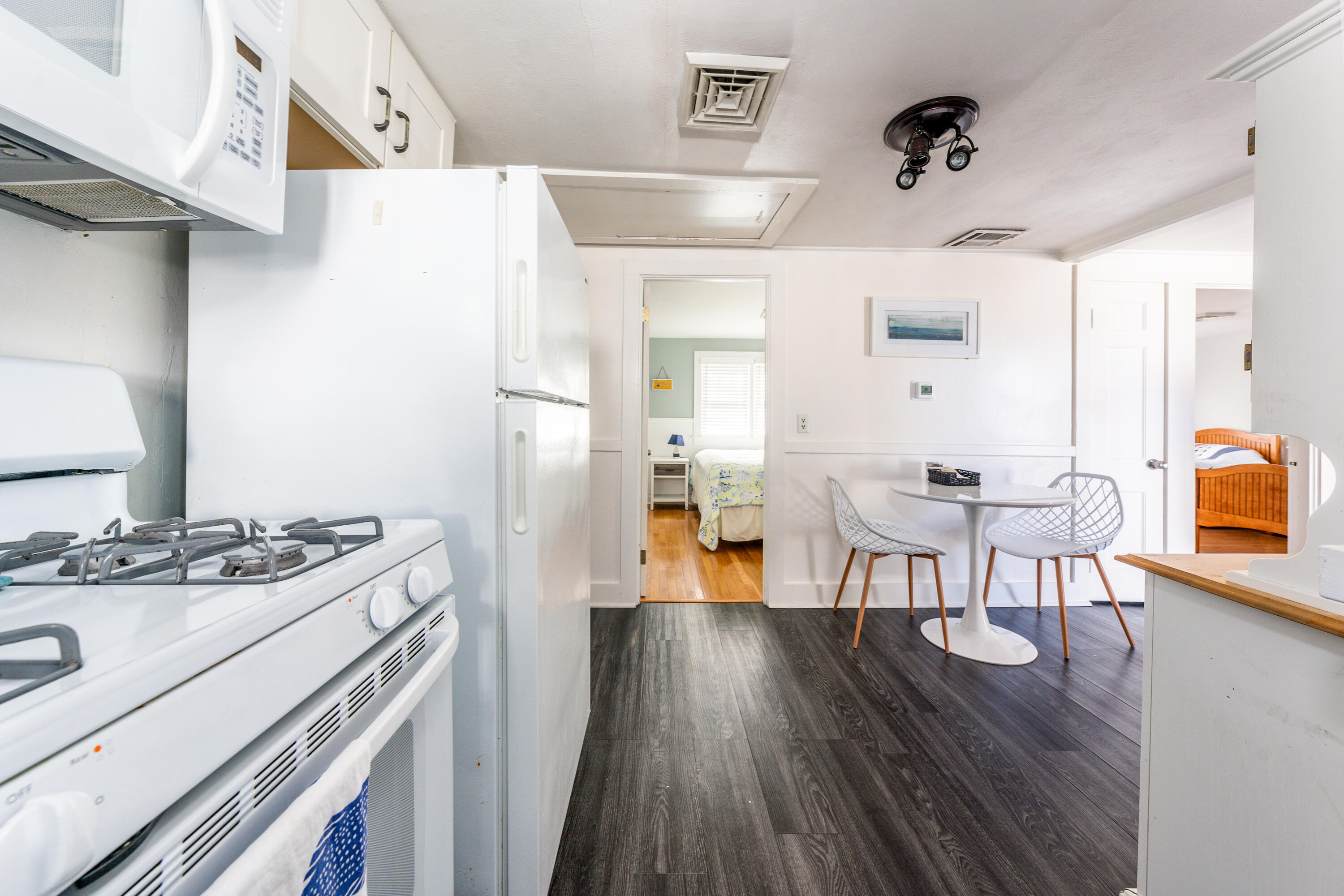 121 Sixth Avenue West Hyannisport, MA 02672 - Photo 8 of 35 a kitchen with stainless steel appliances granite countertop a stove a refrigerator a dining table and chairs with wooden floor
