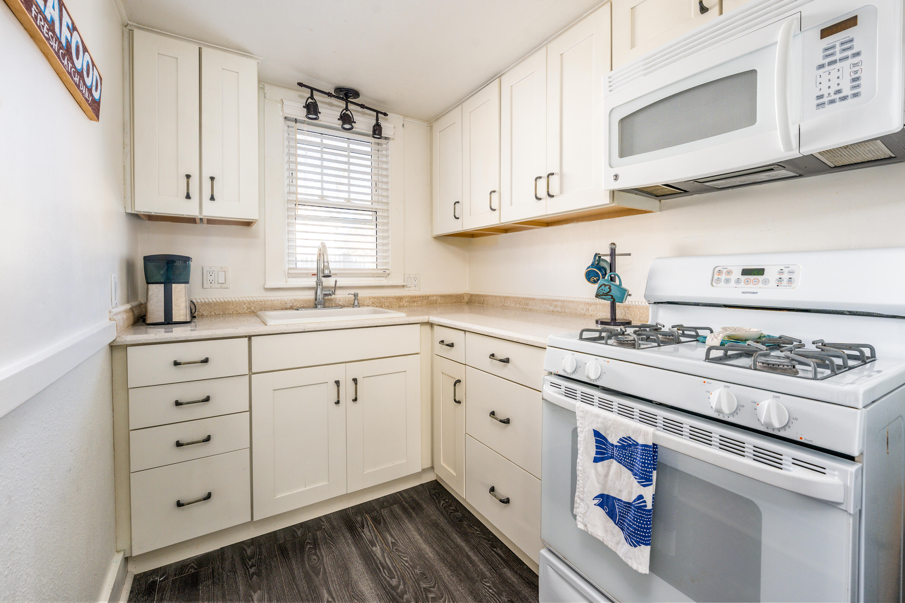 121 Sixth Avenue West Hyannisport, MA 02672 - Photo 9 of 35 a kitchen with granite countertop white cabinets and white appliances