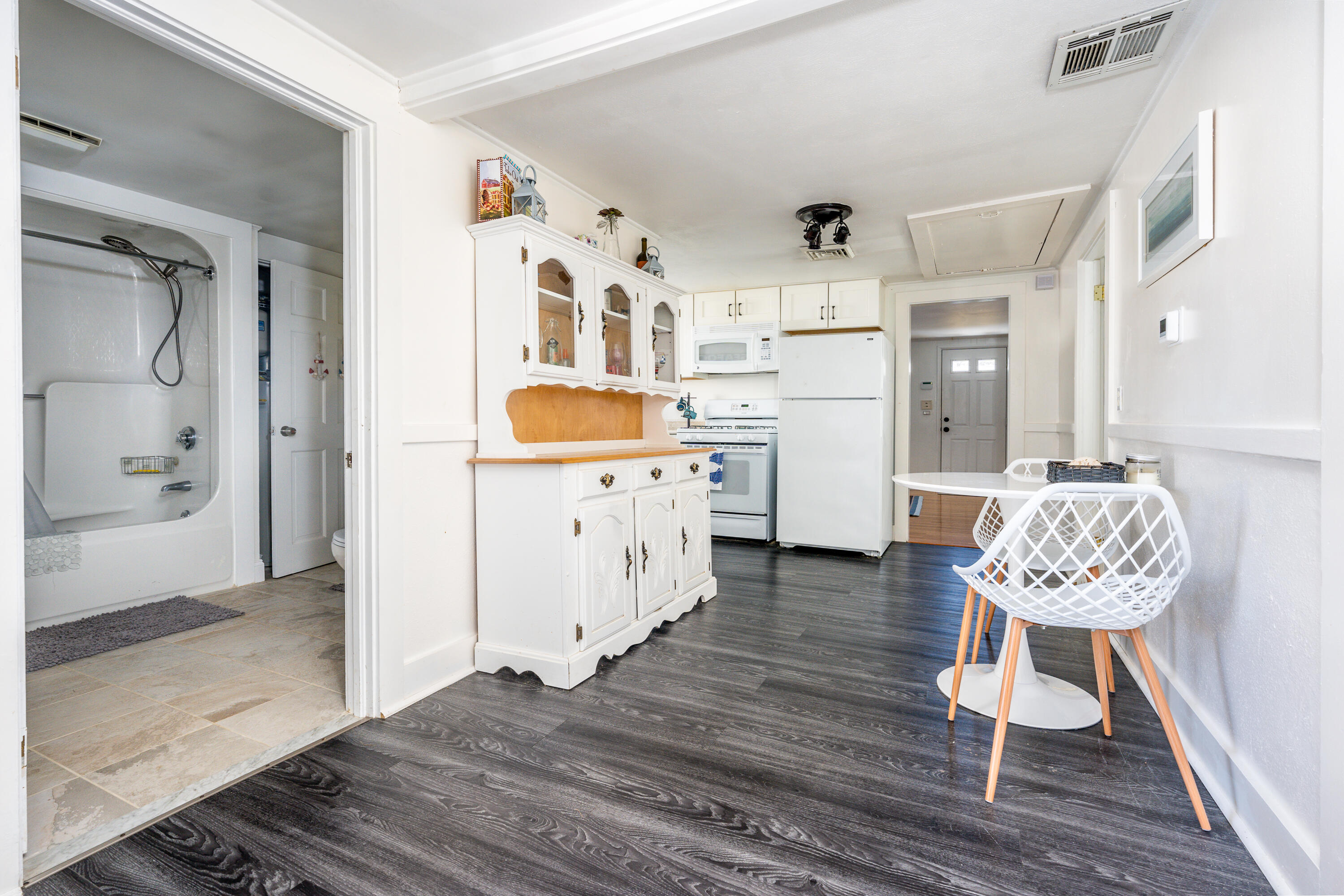 121 Sixth Avenue West Hyannisport, MA 02672 - Photo 10 of 35 a kitchen with stainless steel appliances kitchen island granite countertop a table chairs and wooden floors