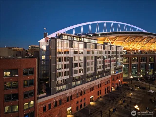 a living room with furniture a flat screen tv and a refrigerator