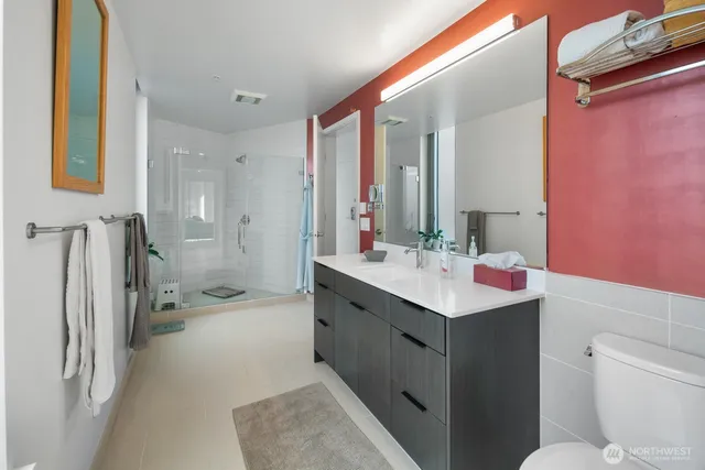 a view of a hallway with wooden floor and a dining room view