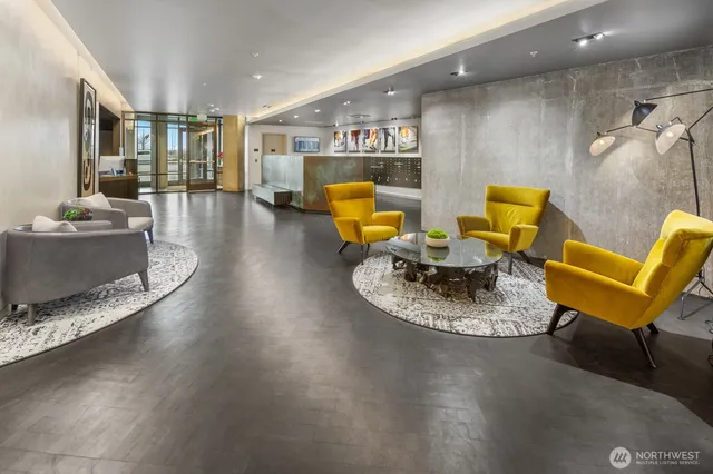 a living room with furniture and floor to ceiling windows