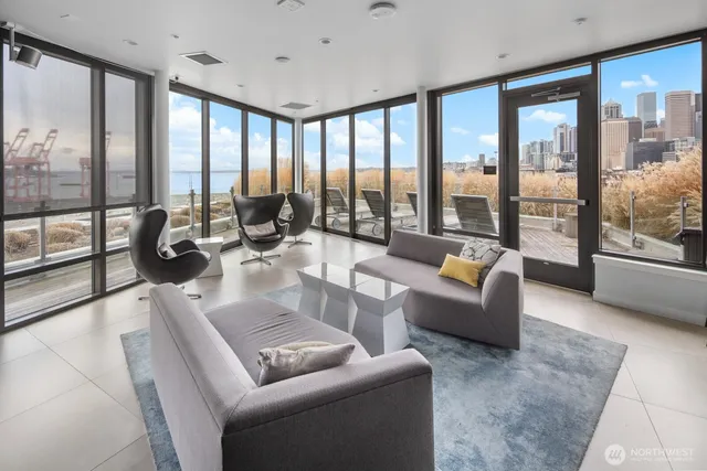 a kitchen with stainless steel appliances a dining table chairs stove and refrigerator